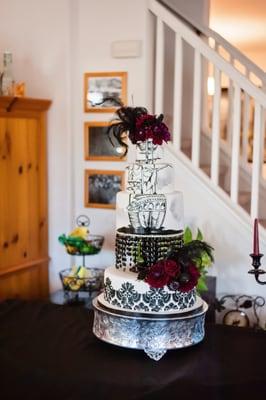 not best photo of it, but pirate cake with black and burgandy flowers and black feathers, made to our specific order, awesome.