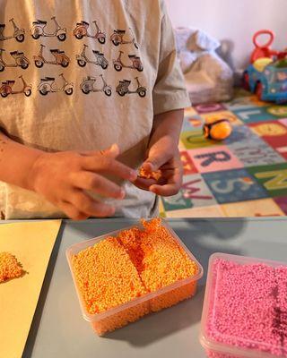 Tiny fingers hard at work -- fine motor fun in action!