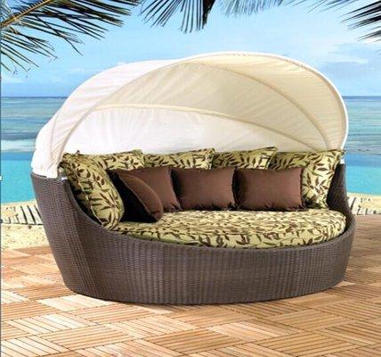 Round daybed with retractable canopy roof.