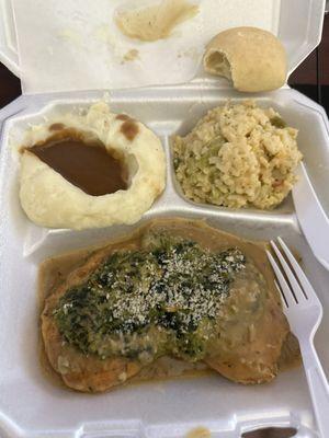 Spinach Chicken, rice dressing, mashed potatoes and gravy, and a roll of