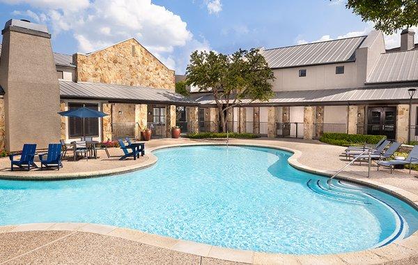 Resort-style swimming pool with ample lounge chairs