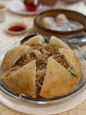 Crispy rice noodles with pickled vegetables and shredded pork.