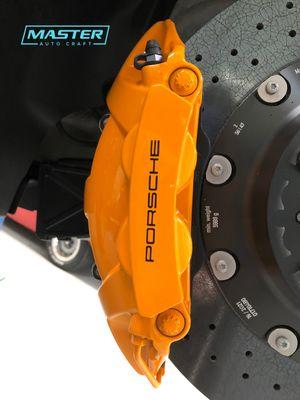 Porsche 992 911 turbo s. Custom caliper painting (mclaren orange). Logo stencil created in-house to Porsche Factory Specifications.