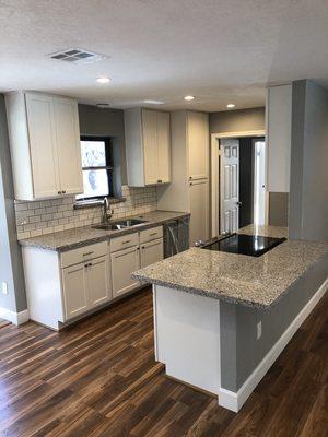 New kitchen cabinets with granite countertops and subway backsplash tile in Friendswood