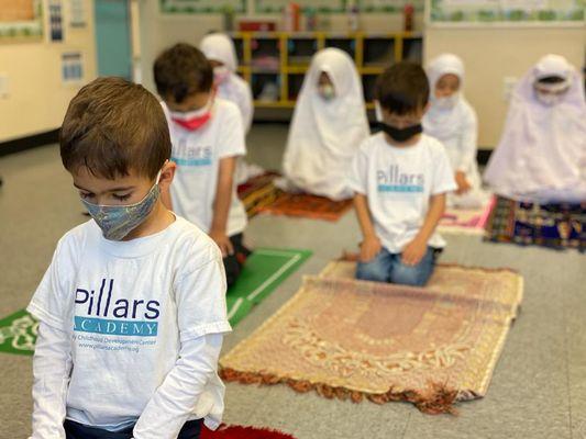 Kindergarteners learning how to pray