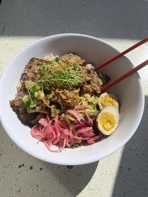 Our Pork Loaf rice bowl with pickled egg. An instant favorite. Our pork options change often and are butchered in house from whole hog!