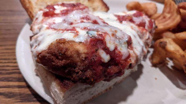 Chicken parmesan sandwich and cottage fries.