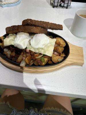 Breakfast skillet with American White Cheese and multigrain toast.