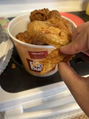 Feathers intact on several pieces of fried chicken