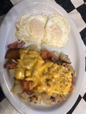 Loaded home fries with two over easy eggs