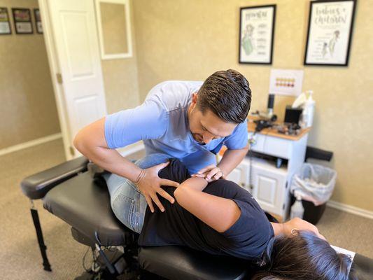 Dr. Johnson manually adjusting a Patient's low back