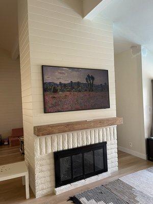 Free standing fireplace install of a 65" frame TV with power and in wall box. Mental install as well