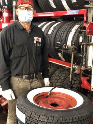 Beto mounting a white wall tire