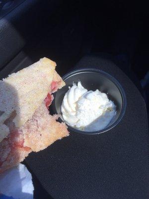 Yummy cherry empanada with cinnamon sugar and fresh whipped cream.