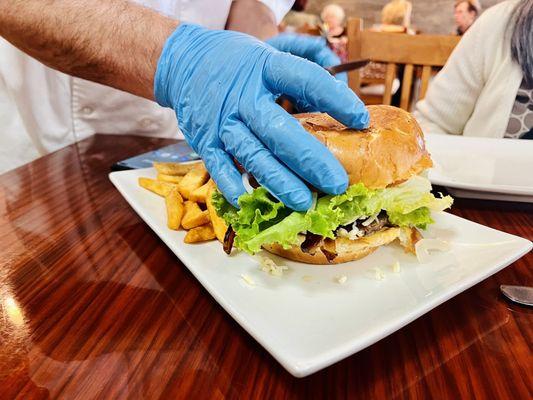 Owner/Chef cutting the burger my colleagues split