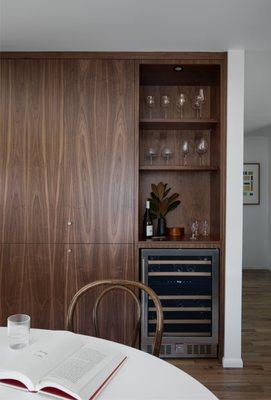 This Mid-Century Modern home featuring grain matched walnut cabinets sure make this kitchen stand out!