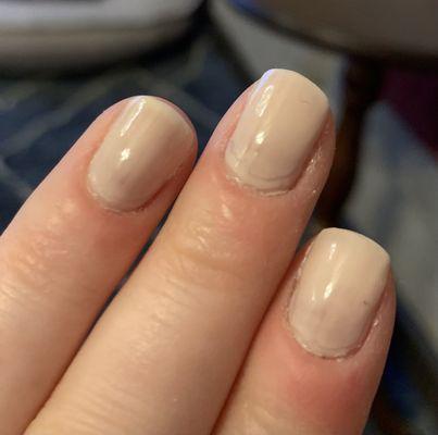 Terrible manicure. Rough cut cuticles and the clear top coat is visibly shorter than the rest of the polish.