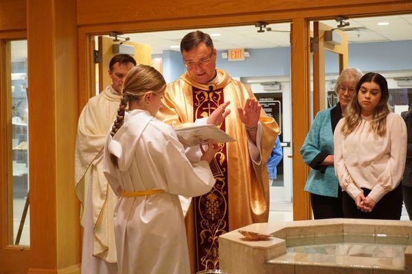 Father Gregg blessing the baptism fountain.