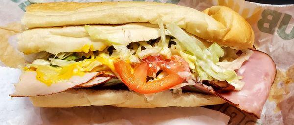 Half of the footlong: All American Club, with ham, turkey, bacon, extra cheese, lettuce, tomato, mayo, mustard,  S & P.