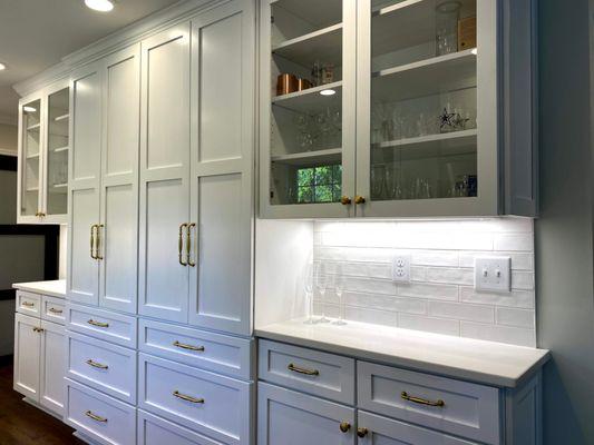 White shaker kitchen with dark hardwoods.