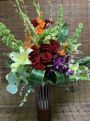 Summer mix of roses, bells, orchids, lilies