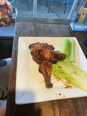 Honey, barbecue chicken wings with celery