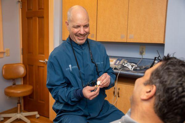 Dr. Gregory Toback talking to a patient about different implant options