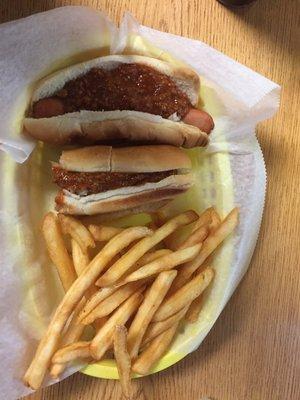 Two hotdogs with chili and onions and extra crispy French fries!