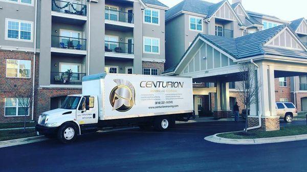 Centurion Moving truck outside Overland Park, KS apartment complex for long distance move.