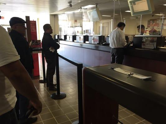 This customer monopolizing the single teller. 10 in line. This is why this bank sucks, it's 9:45am and they have one teller.