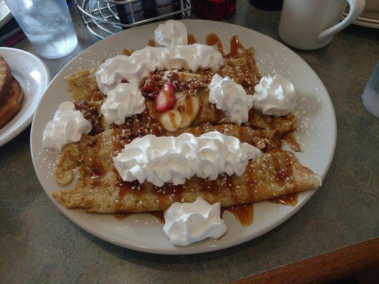 These crepes are stuffed with cream cheese and strawberries and bananas.  Delicious, I can't believe I ate the whole thing.