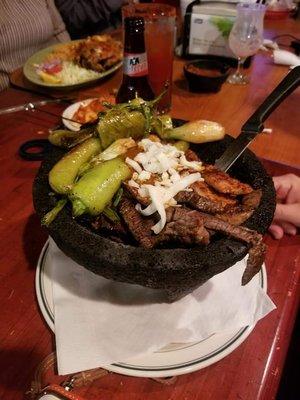 Molcajete filled with shrimp, chicken and beef. Lots of food. Definitely a 2-3 person meal.