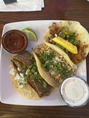 From left to right: gyro taco, grilled chicken taco, al pastor taco all with cilantro and onion