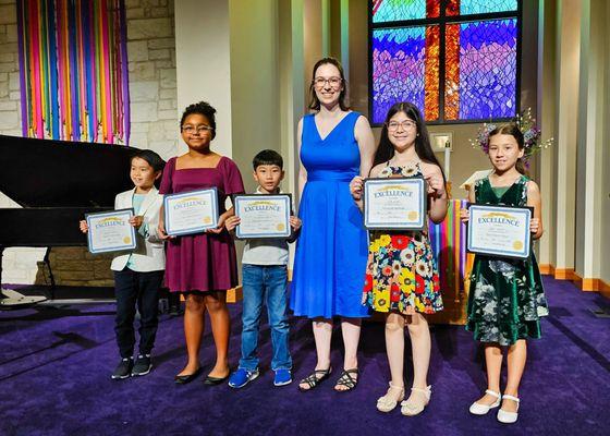 Students with teacher after piano recital