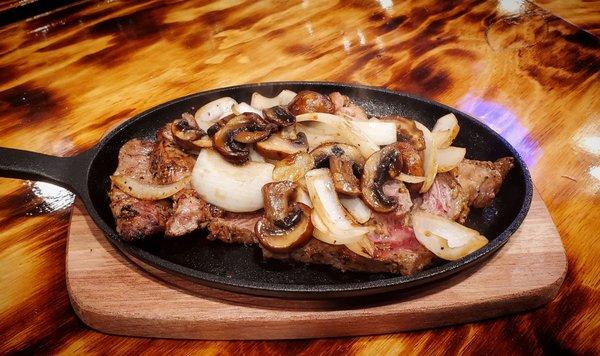 Ribeye Steak with mushrooms and onions.