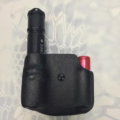 Custom Kydex holster for a flashlight and spare battery.