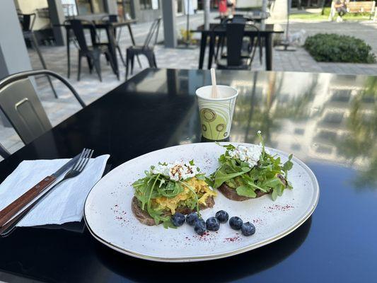 Avocado toast with arugula and eggs topped with cottage cheese