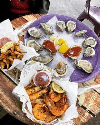 Fried crab claws, boiled shrimps, and raw oysters.