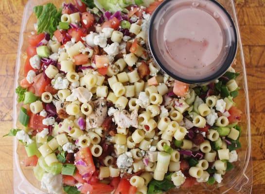 Chopped Salad: Crispy Romaine, Chopped Chicken, Ditalini Pasta, Tomato, red Cabbage, Gorgonzola Cheese, Bacon, Sweet Vinaigrette, etc.