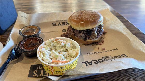 Brisket sandwich and cabbage slaw. Sides are spicy bbq sauce and Carolina bbq sauce