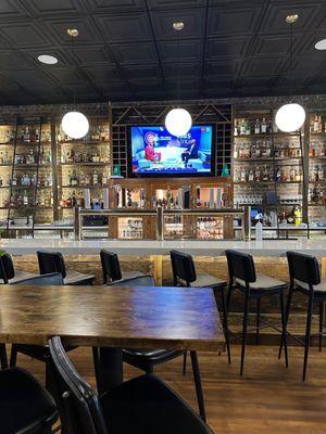 A look at the bar - you can see the beer taps under the TV.  The liquor is organized in sections - whiskey on the right.