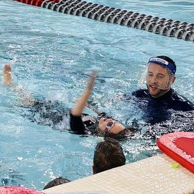 My seven year old son with Mr. Matt. He swam the backstroke, down and back the full 25 meter lane! 50 meters. So proud!