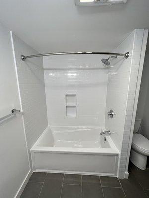 Replaced a one piece fiberglass tub with a new tub and new acrylic subway surround to ceiling height . Near Plymouth, Ma