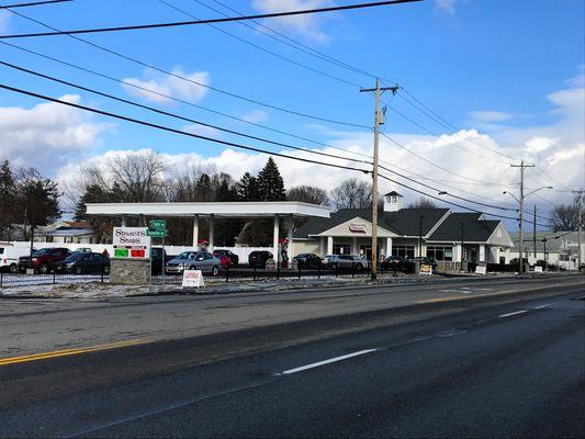 View of the shop from across the street. In this image you can see our gas pumps and the entrance.