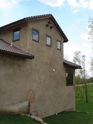 Exterior stucco with faux brick knockout. Faux wood beams.