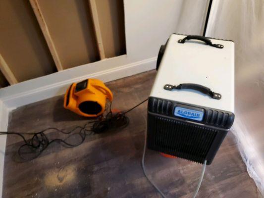 Dehumidifier and air mover in a confined space.