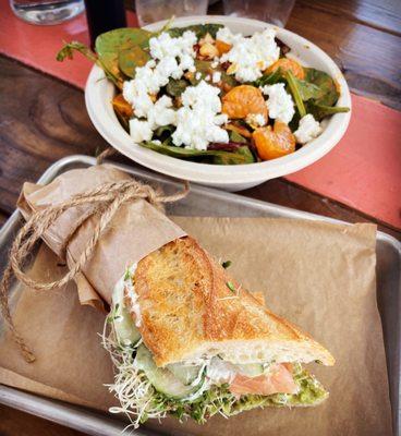 Smoked salmon baguette with caper cream cheese and sprouts Spinach & mandarin salad