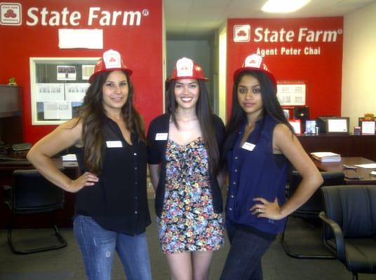 Team members sporting the State Farm Fireman hat.