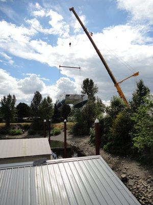 One of Schooner Creek Boat Works custom built catamarans getting launched by crane.