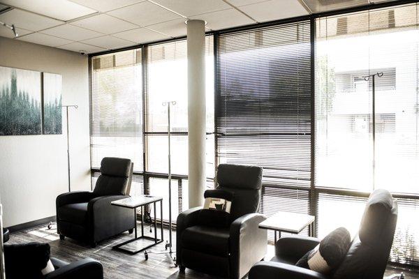 One of our treatment rooms - comfortable chairs, plush blankets, charging outlets and TV.